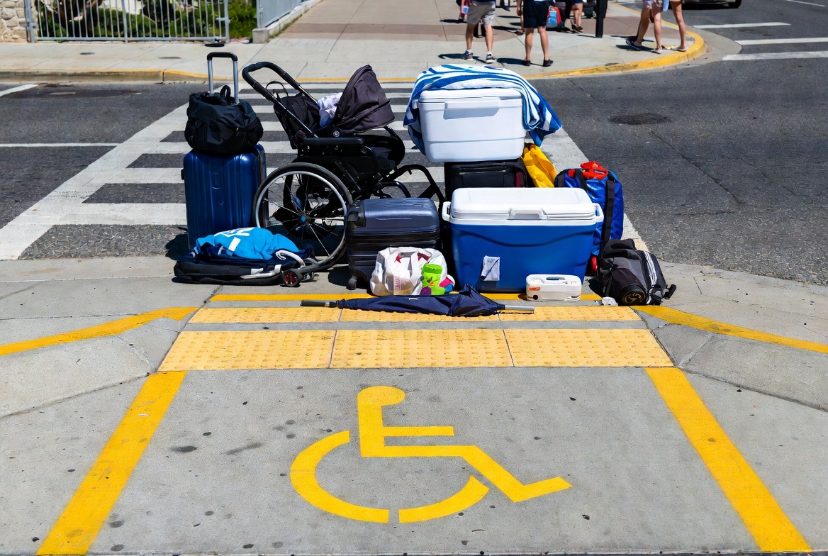 CurbsideBlocked Luggage and travel gear blcok an accessible handicap crossing