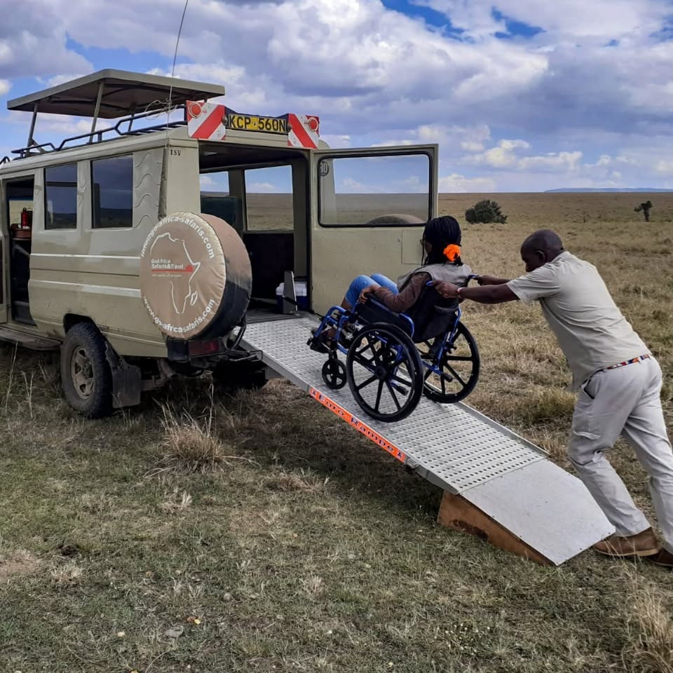 AccessibleAfrica A wheelchair user is helped into a safari vehicle during a trip to Africa.
