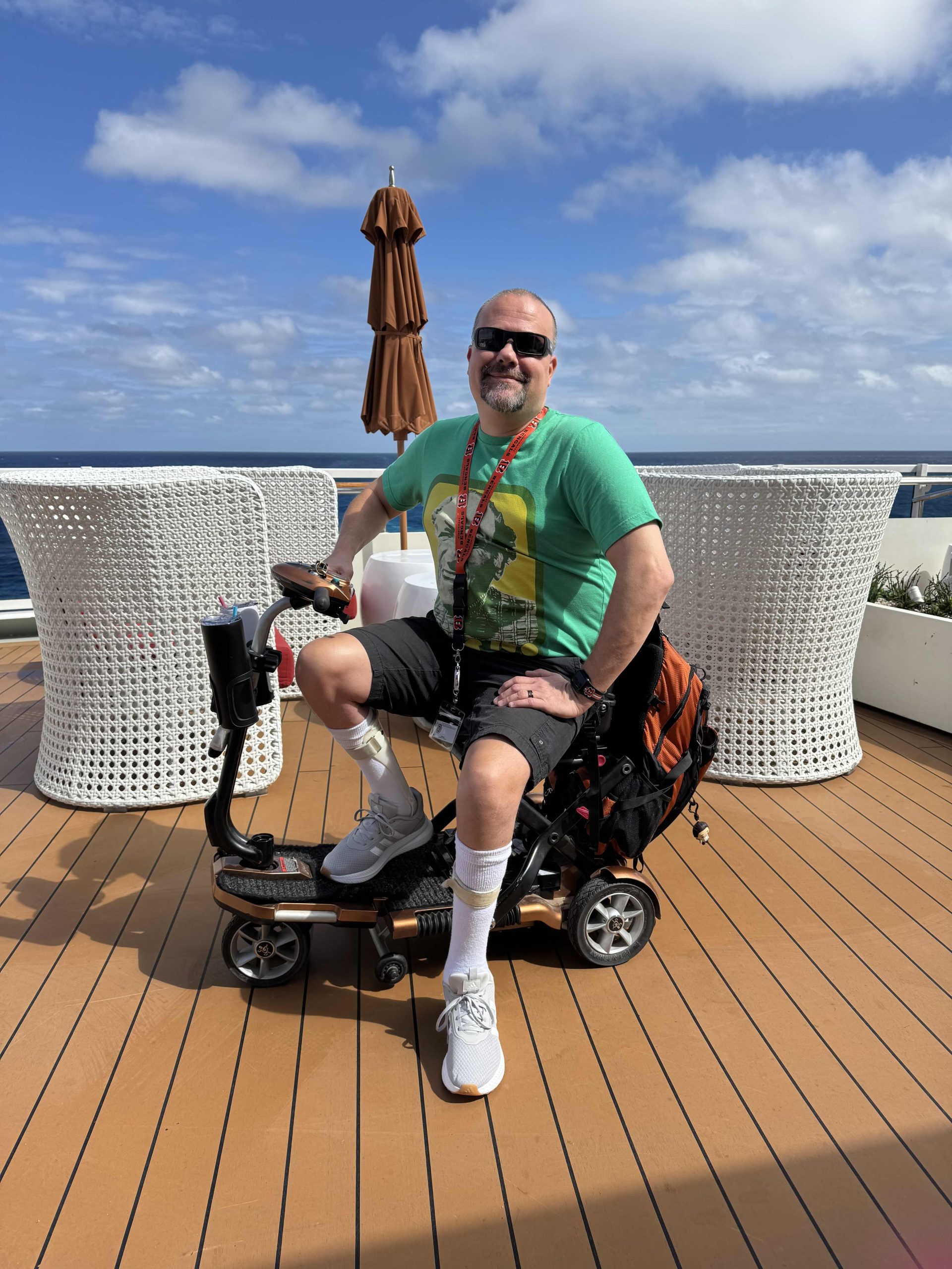 Jimmy Dinsmore is seen here on the deck of a cruise ship with a mobility scooter.